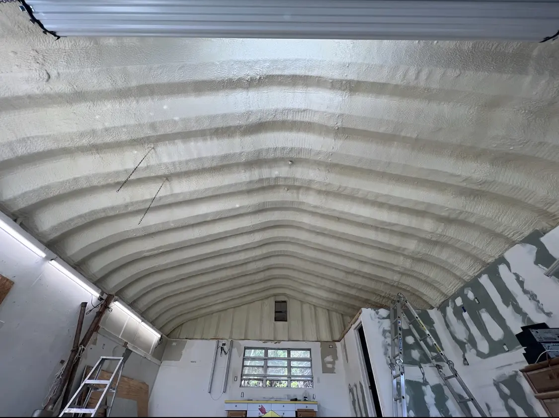 Spray polyurethane foam applied to the underside of a metal roof deck in Sanger